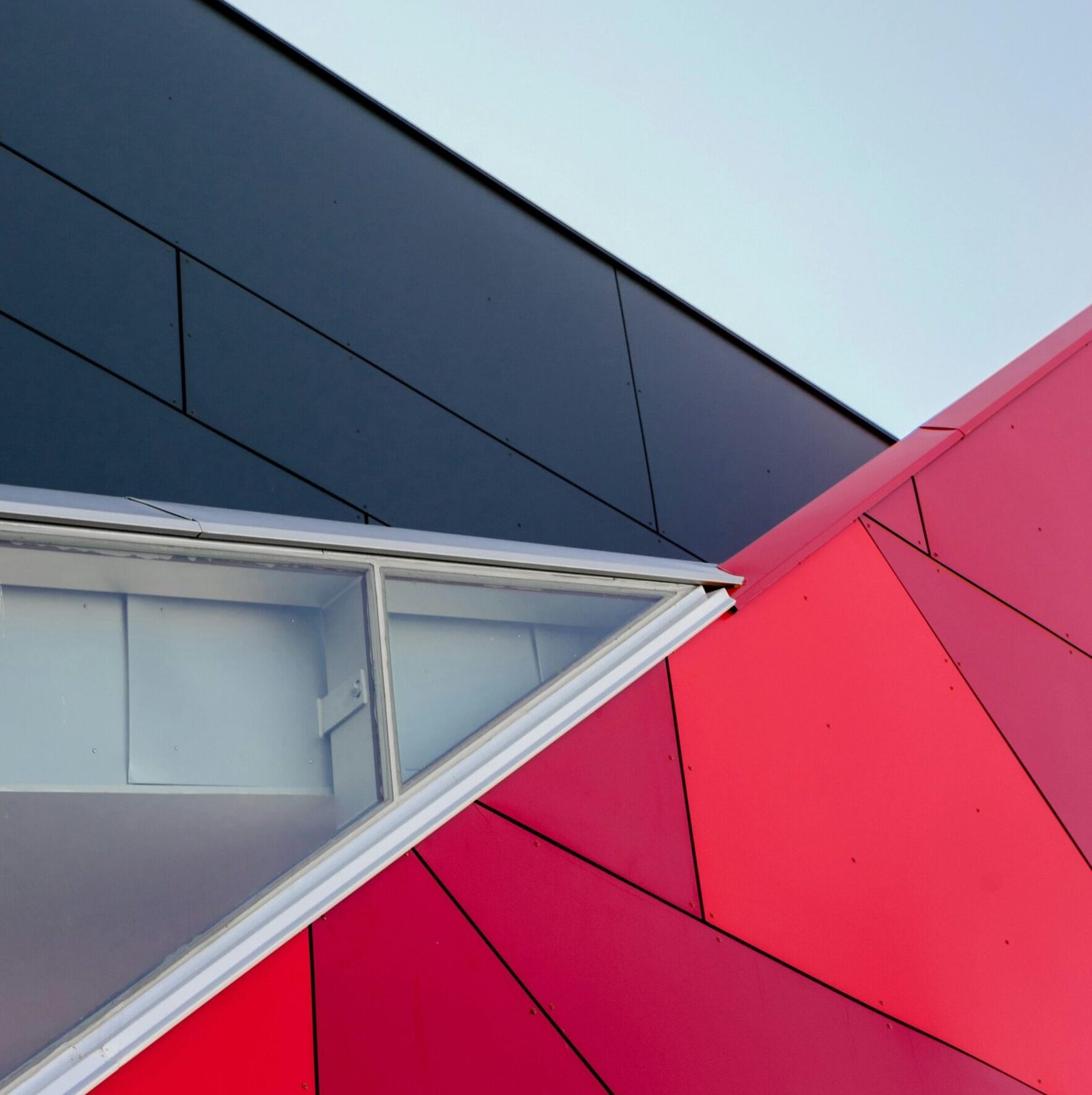 A low-angle view of a modern geometric building facade with bold colors in London, ON, Canada.